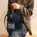 black tote bag with mini bag charm model